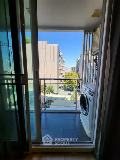 Modern balcony with washing machine and city view, perfect for urban living.