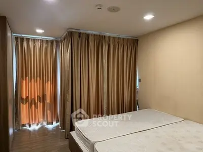 Cozy bedroom with twin beds and warm lighting, perfect for relaxation.