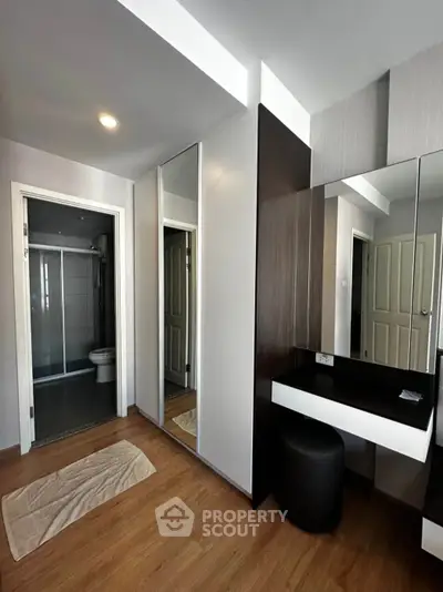 Modern bedroom with ensuite bathroom and sleek vanity area