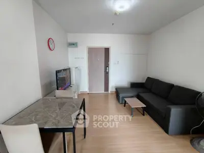 Modern living room with sleek furniture and wooden flooring, perfect for cozy gatherings.