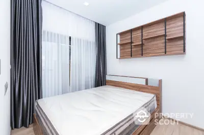 Modern minimalist bedroom with wooden bed and shelves, featuring floor-to-ceiling curtains and natural light.