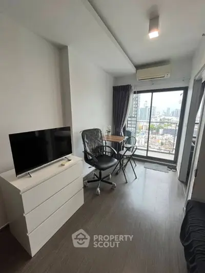 Modern apartment with city view, featuring sleek furniture and natural light.