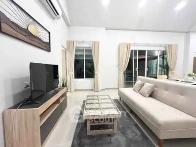 Modern living room with sleek furniture and natural light, perfect for relaxation and entertainment.