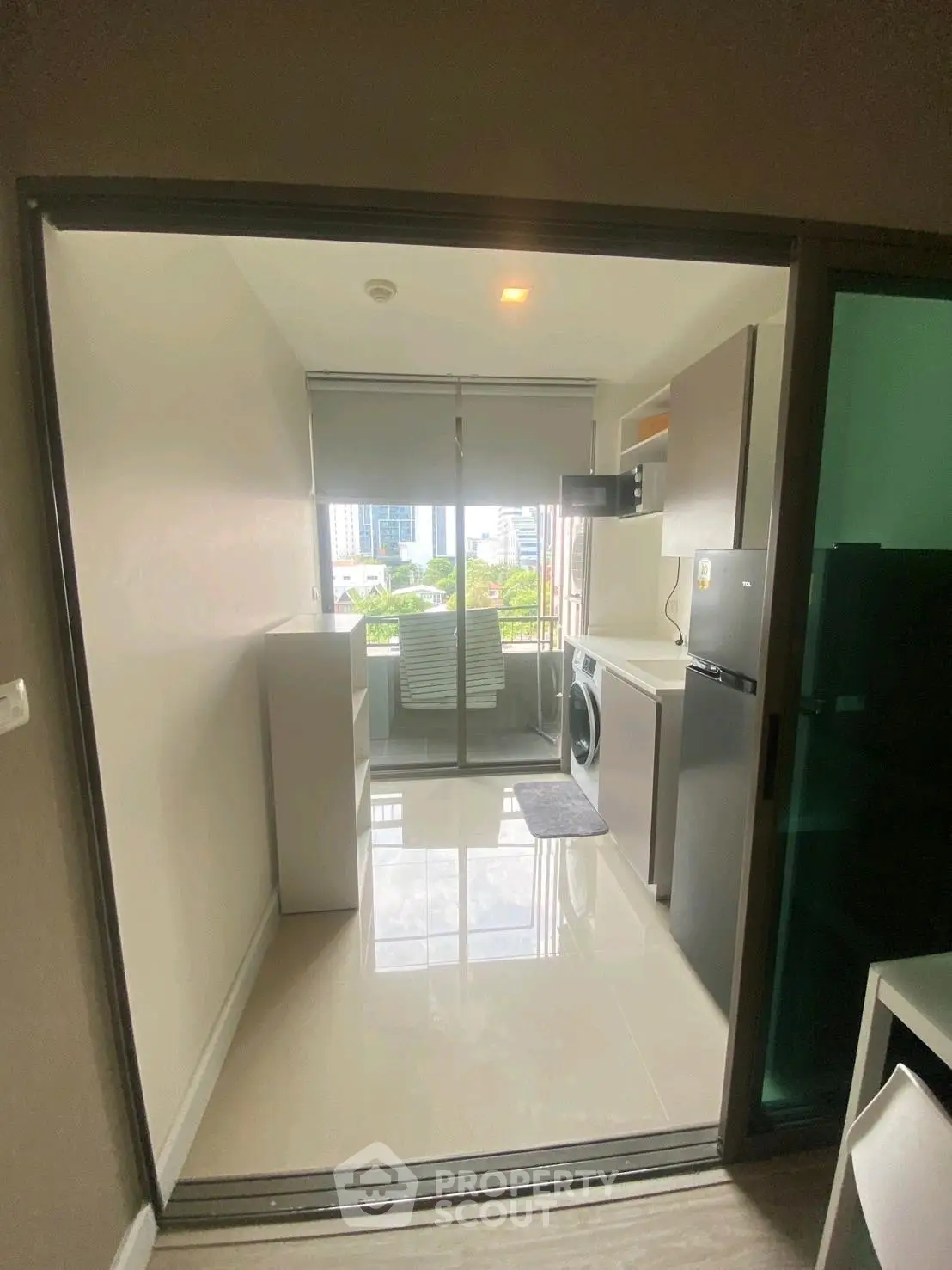 Modern apartment kitchen with sleek appliances and city view, perfect for urban living.