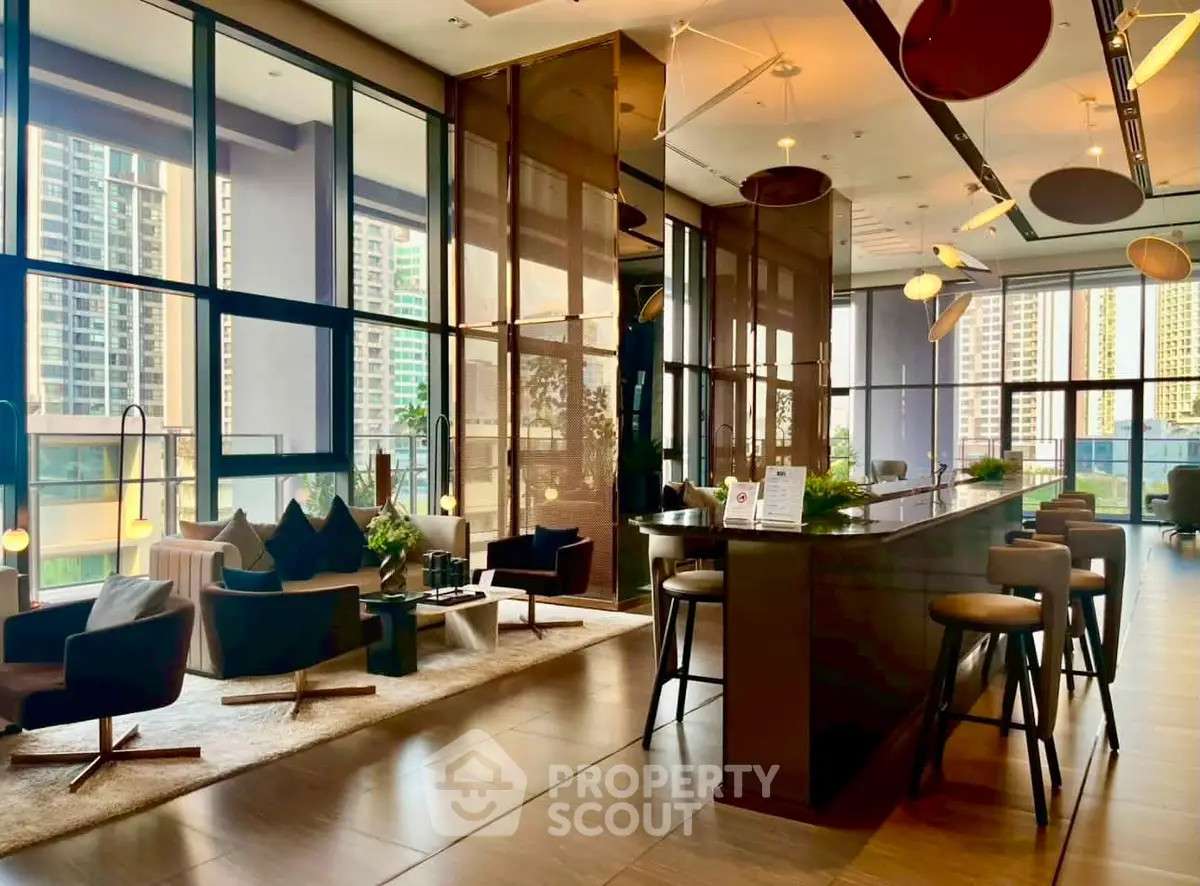 Luxurious modern living room with floor-to-ceiling windows and stylish furniture in a high-rise building.
