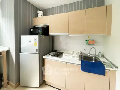 Modern compact kitchen with sleek cabinets and stainless steel appliances