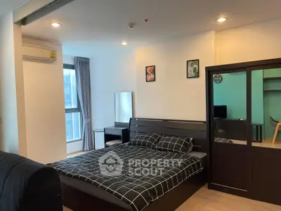 Modern bedroom with stylish decor and ample natural light in a contemporary apartment.