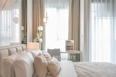 Luxurious bedroom with elegant decor and soft lighting, perfect for relaxation.