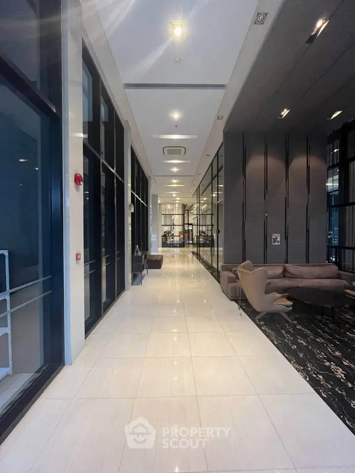 Luxurious modern building lobby with sleek design and comfortable seating area.