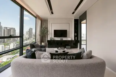 Luxurious modern living room with panoramic city view and elegant furnishings.