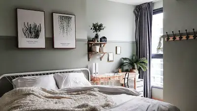Cozy bedroom with stylish decor, large window, and elegant workspace, perfect for modern living.