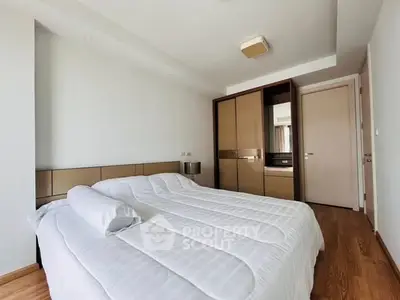 Modern bedroom with sleek wardrobe and cozy bed in minimalist style.