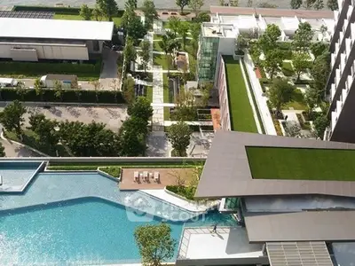Luxurious rooftop pool with stunning cityscape views and lush greenery in a modern urban setting.