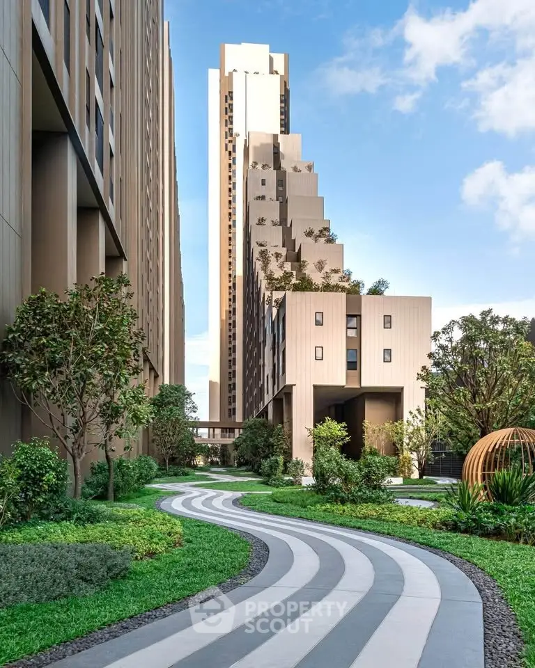 Modern high-rise building with lush landscaped garden and unique architectural design.