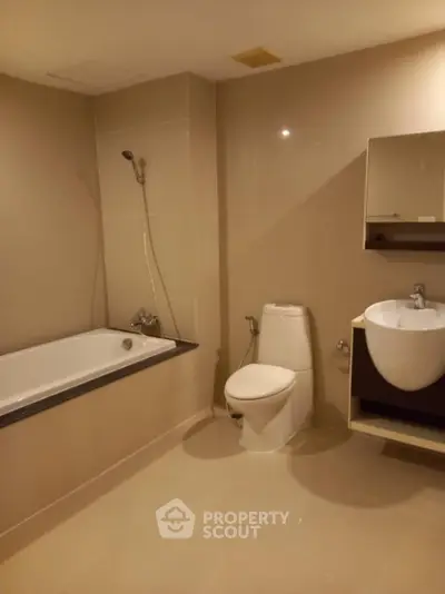 Modern bathroom with bathtub and sleek fixtures in a contemporary apartment.