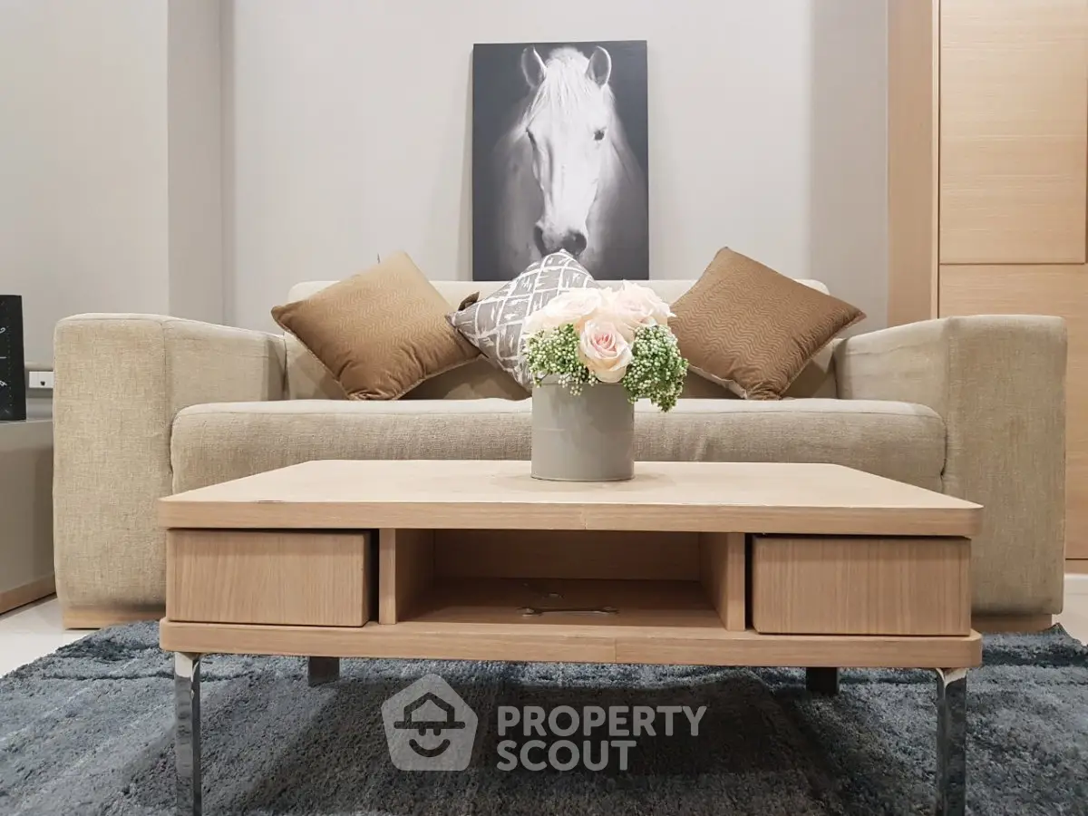 Stylish living room with modern sofa, elegant coffee table, and horse artwork for a cozy ambiance.