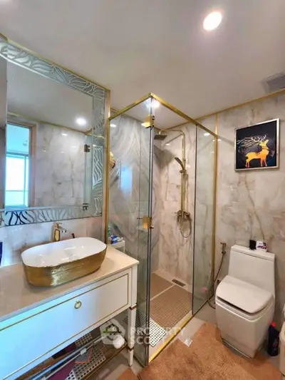 Luxurious bathroom with gold accents and modern shower design