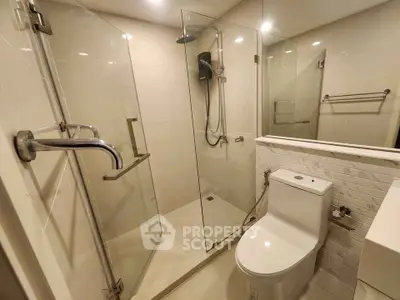 Modern bathroom with glass shower enclosure and sleek fixtures