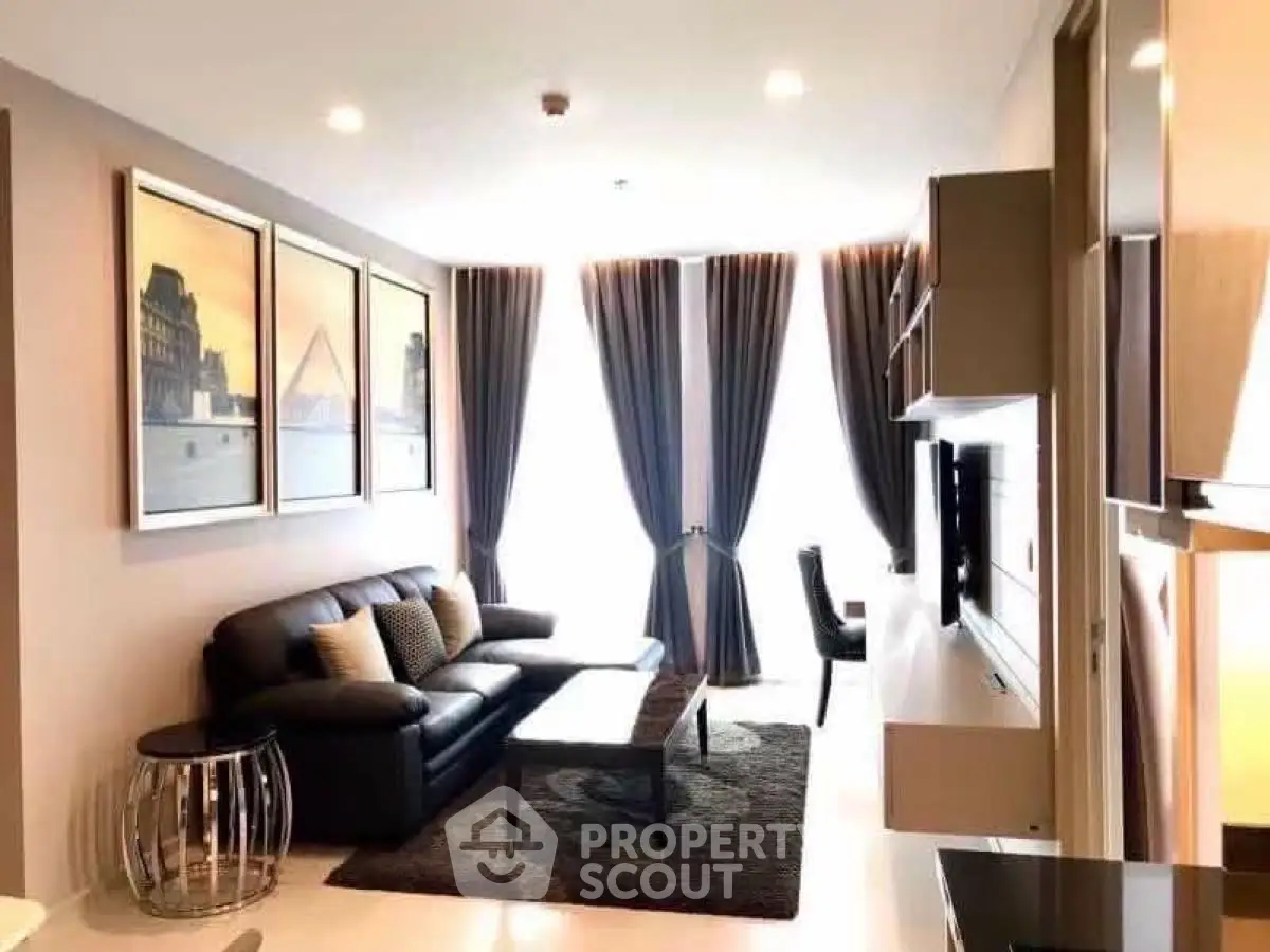 Modern living room with elegant decor and large windows for natural light.