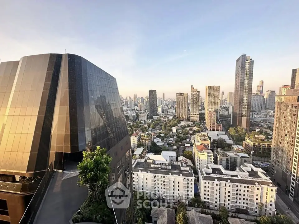 Stunning cityscape view from a high-rise building balcony, showcasing urban skyline and modern architecture.