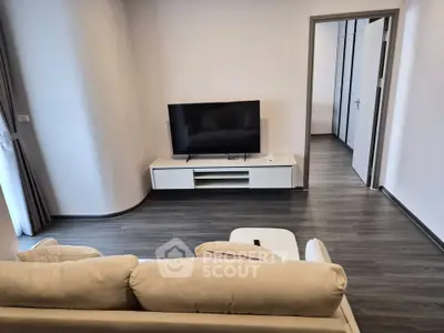 Modern living room with sleek TV setup and stylish flooring