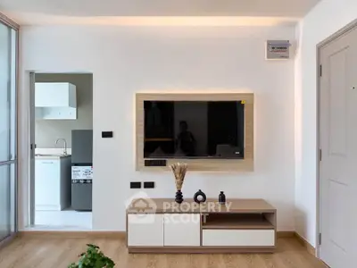 Modern living room with sleek TV setup and wooden flooring