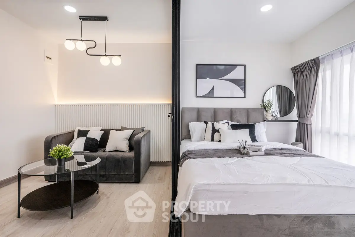 Modern studio apartment with stylish living area and cozy bedroom