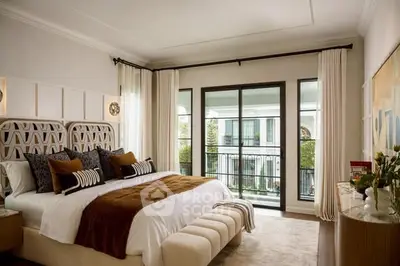 Luxurious bedroom with elegant decor and large windows overlooking a serene view.