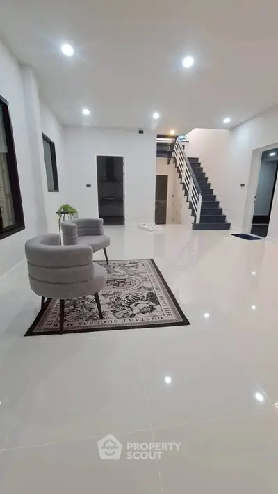 Spacious modern living room with elegant staircase and stylish furniture