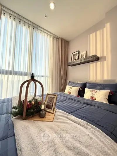 Cozy bedroom with large windows and elegant decor, perfect for relaxation.