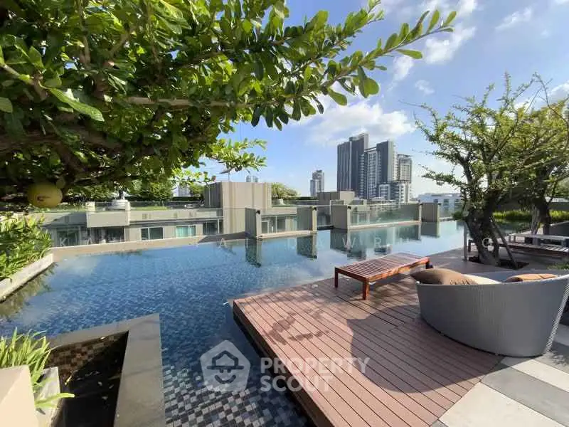 Luxurious rooftop pool with stunning city skyline views and modern outdoor seating.