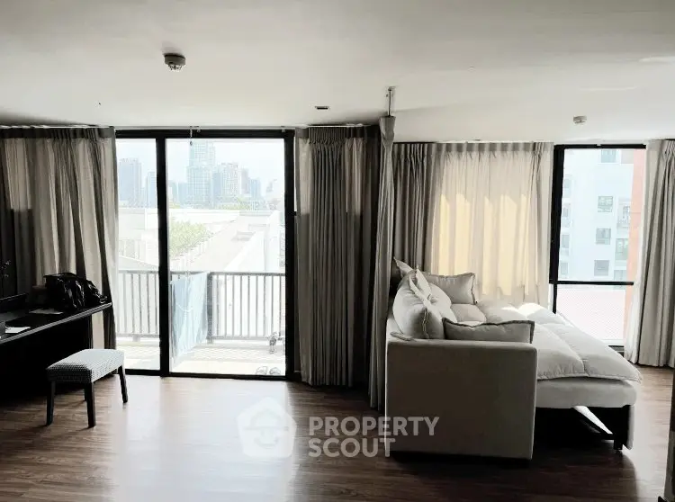 Spacious living room with city view and modern furnishings