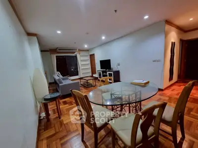 Spacious living room with elegant parquet flooring and modern furniture in a high-rise apartment.