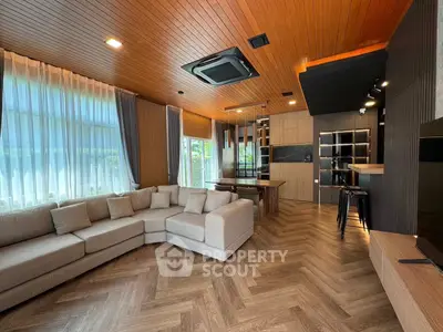 Spacious modern living room with stylish wooden ceiling and large sectional sofa