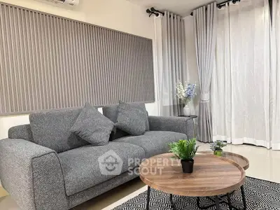 Modern living room with stylish gray sofa and elegant decor