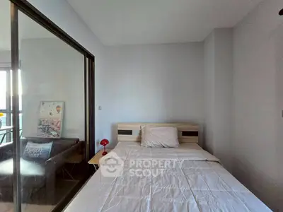 Modern bedroom with glass partition and cozy decor in urban apartment