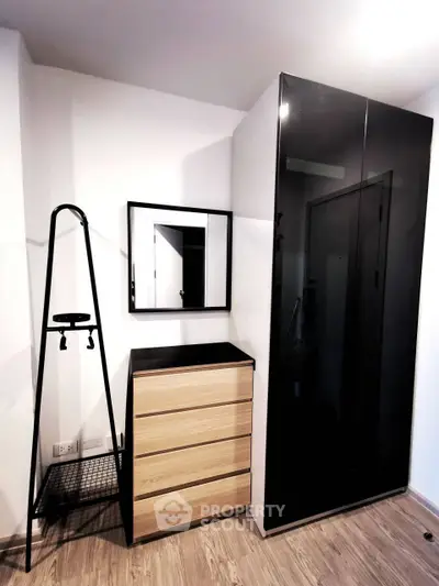 Modern bedroom corner with sleek wardrobe and stylish dresser