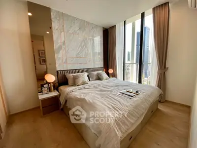 Luxurious bedroom with city view and elegant decor in modern apartment