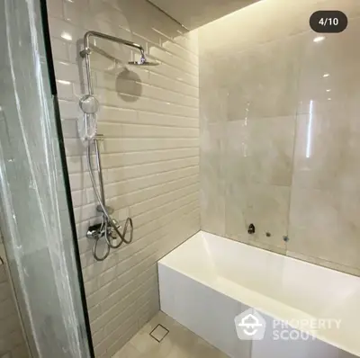 Modern bathroom with sleek finishes, featuring a glass shower, chrome fixtures, and a minimalist bathtub for a serene home spa experience.