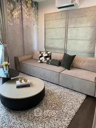 Stylish living room with modern sofa, chic decor, and natural light for a cozy ambiance.