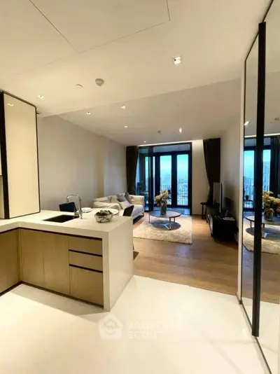 Modern open-plan living room with sleek kitchen and stunning city view