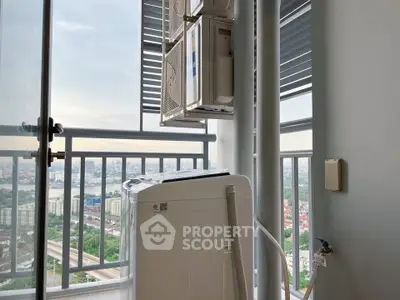 High-rise balcony with washing machine and city view, perfect for urban living.