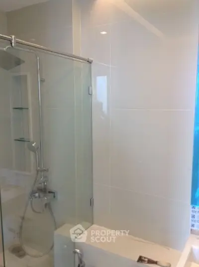 Modern bathroom with glass shower enclosure and sleek fixtures