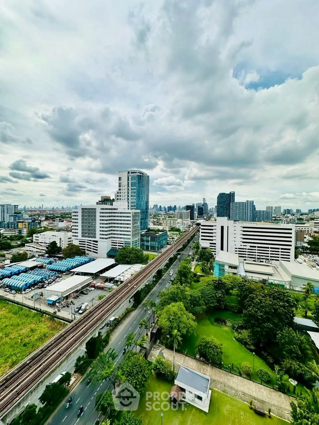 Stunning cityscape view with lush greenery and modern architecture, perfect for urban living.