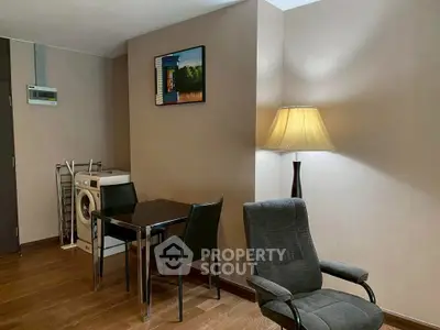 Cozy living area with modern furniture and washing machine in stylish apartment.