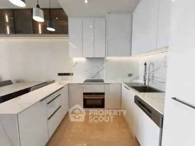 Modern kitchen with sleek white cabinets and marble countertops