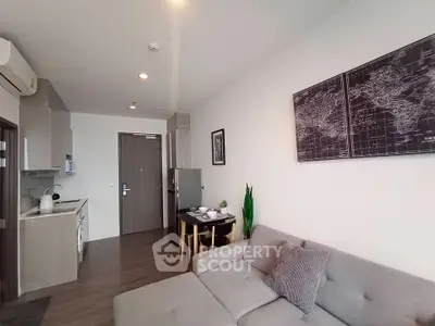 Modern open-layout living room with cozy sofa and stylish kitchen area