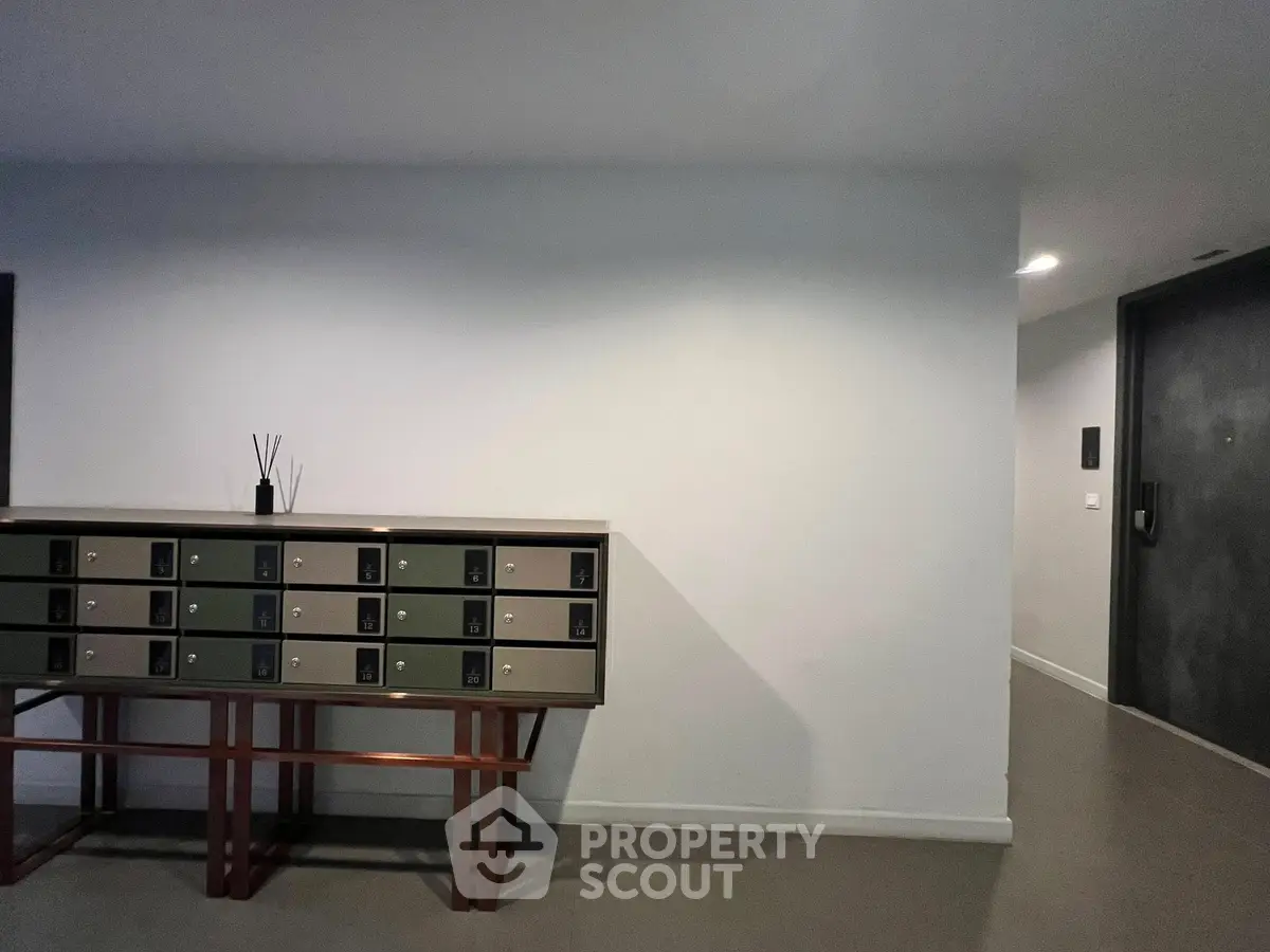 Modern apartment entrance with stylish mailbox setup and sleek design.