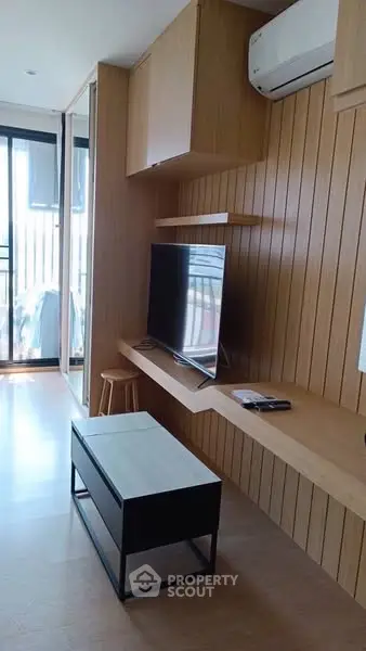 Modern living room with sleek wooden paneling and stylish furniture
