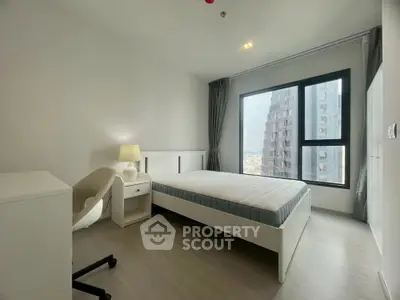 Modern minimalist bedroom with city view, featuring sleek furniture and large window for natural light.